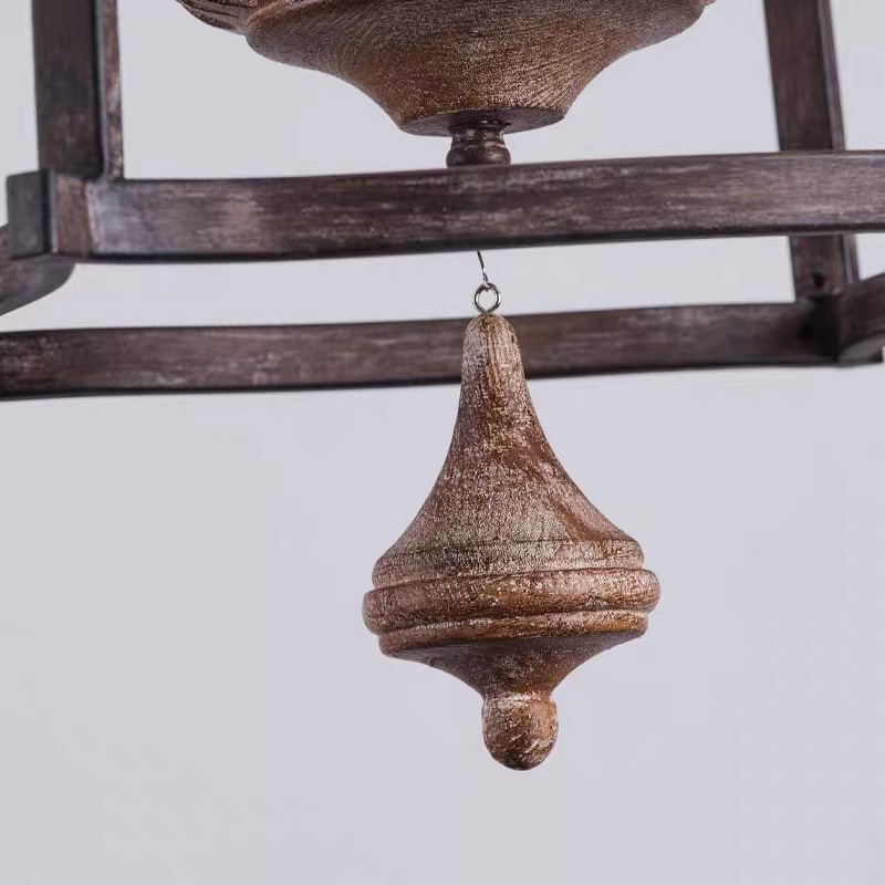 Lower finial and hanging accent detail of rustic birdcage pendant lamp