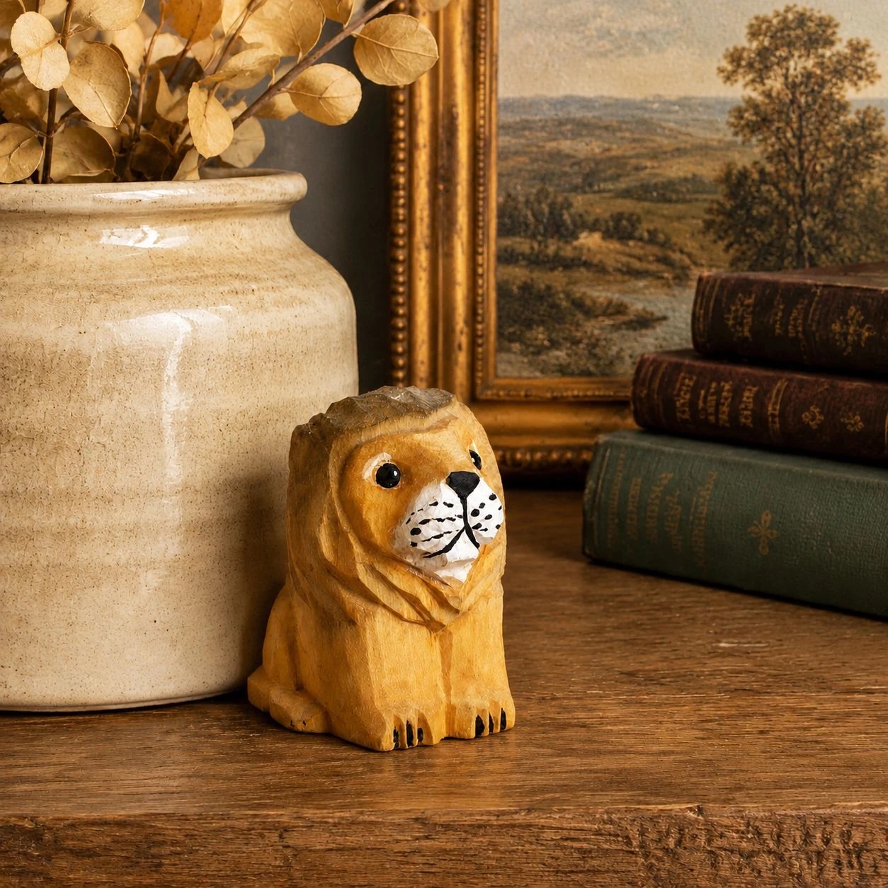 Wooden lion figurine with books and vase