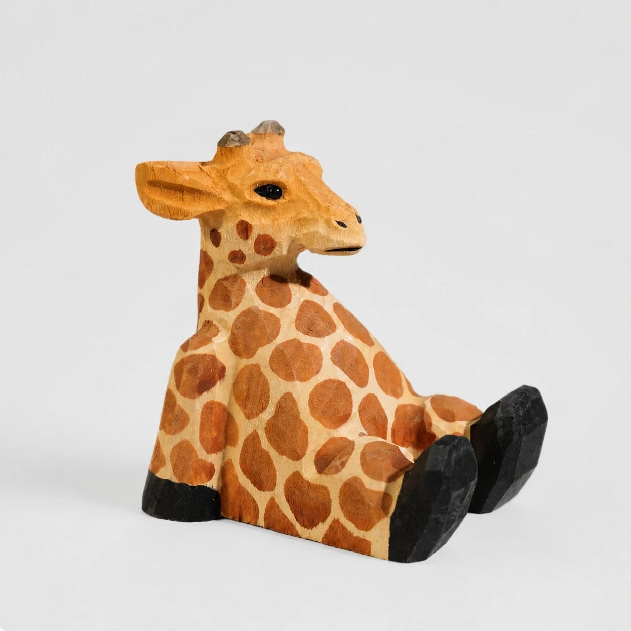 Hand-carved wooden animal phone stand