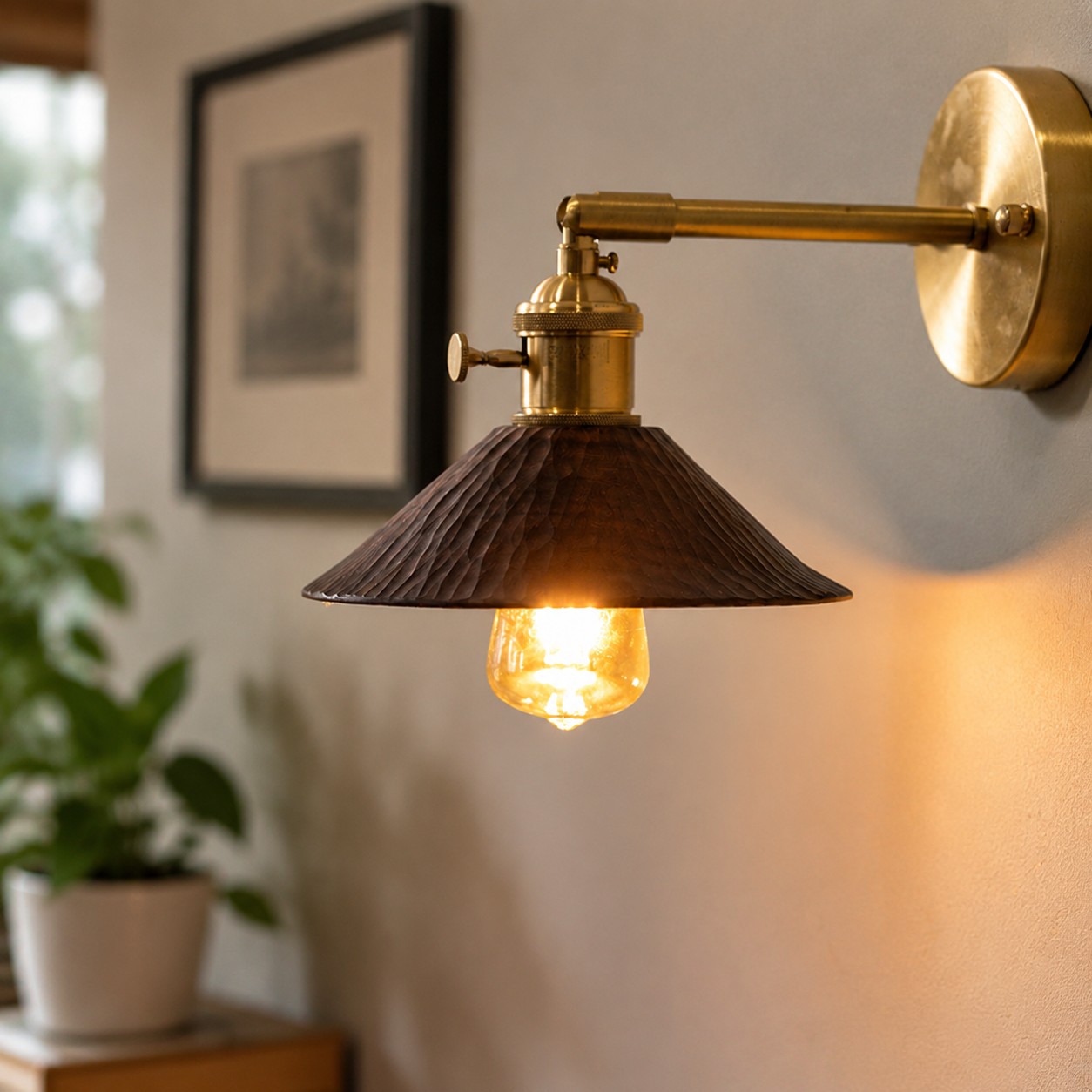 Wood and brass wall sconce beside an indoor plant