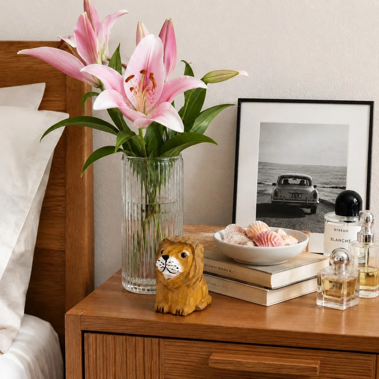 Small wooden lion figurine styled on a bedside table