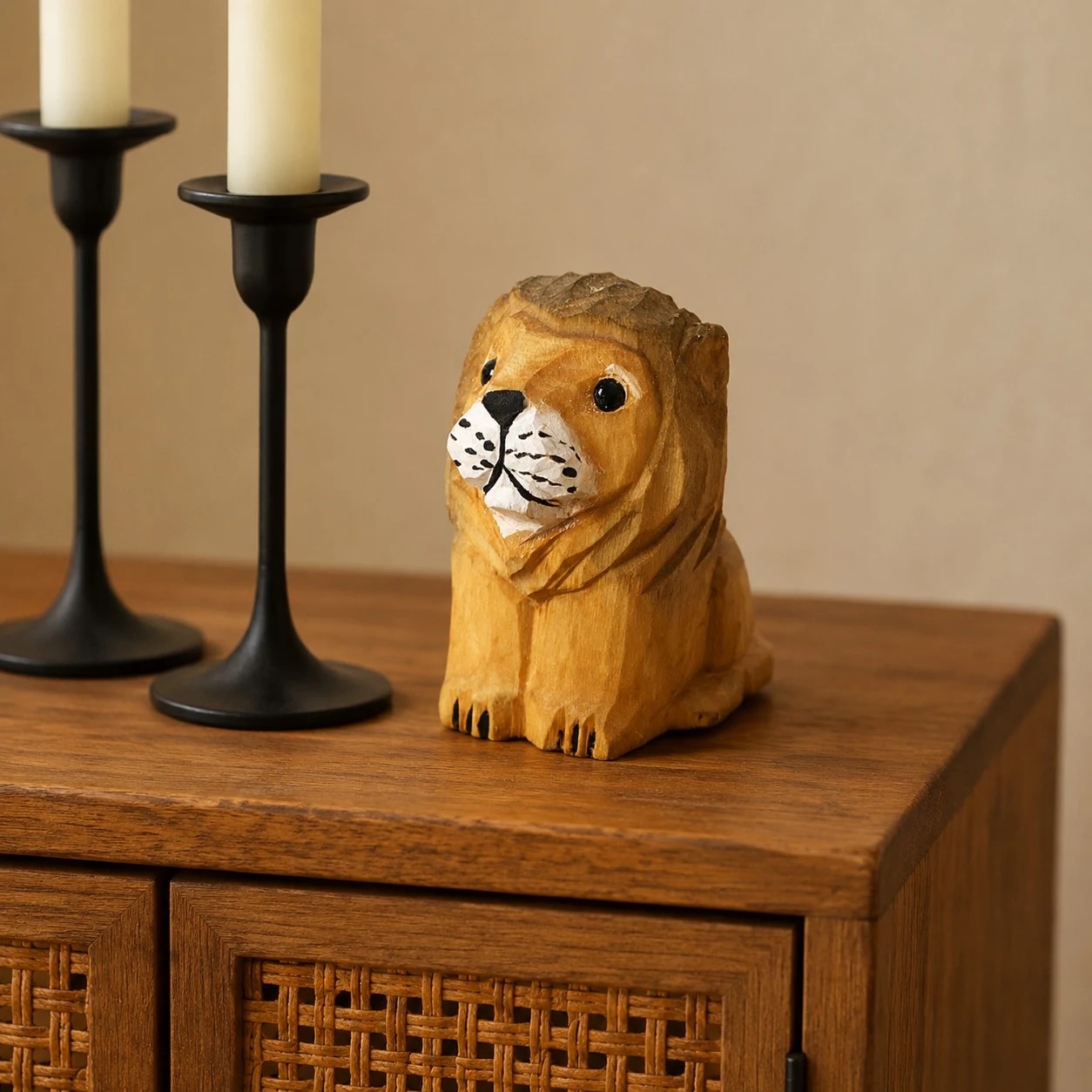 Wooden lion figurine styled on a cabinet