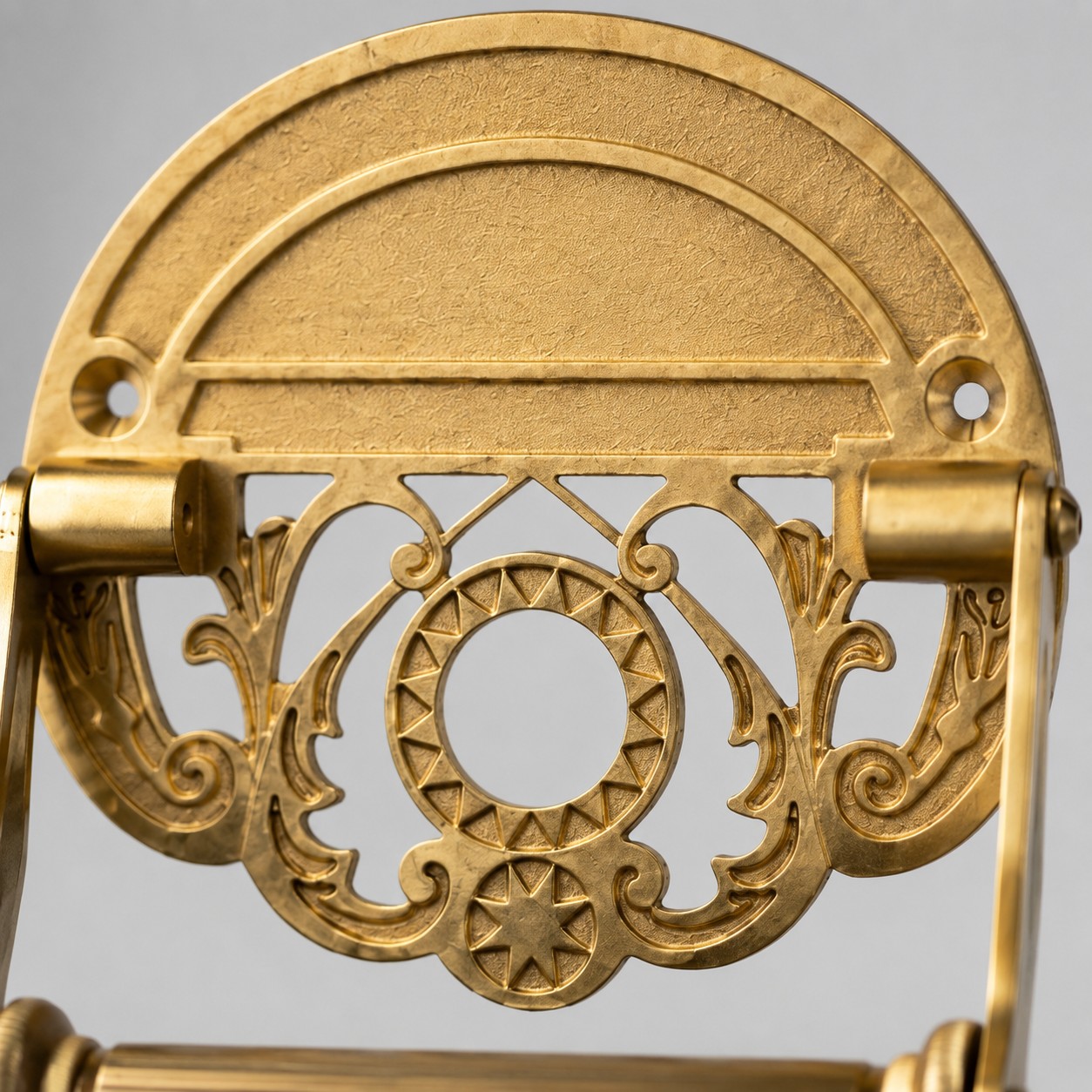 Close view of carved antique brass backplate
