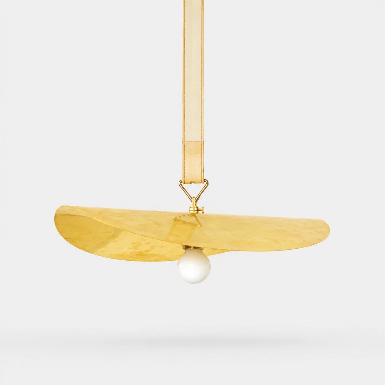 Sculptural brass leaf pendant light with belt-style suspension