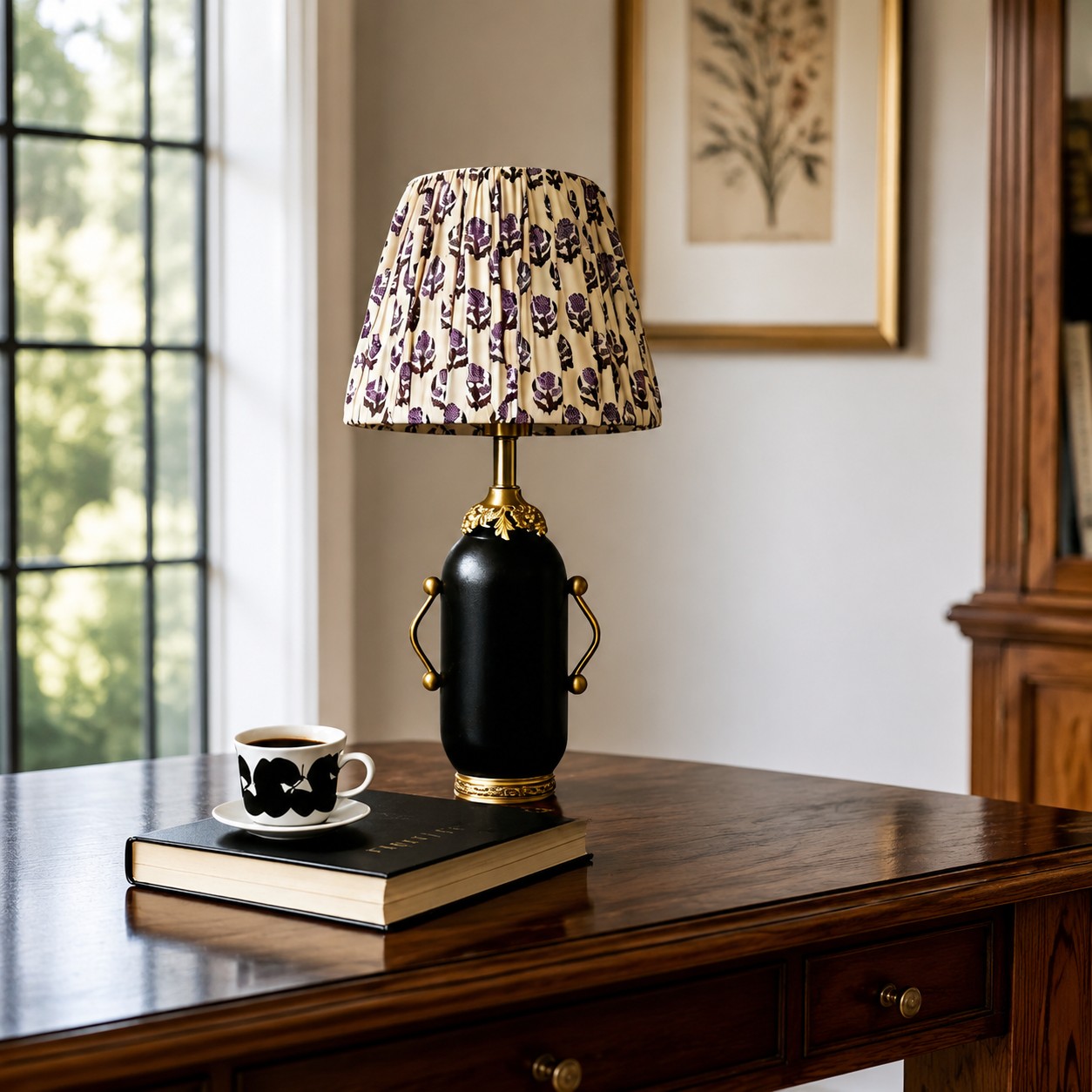 Matte black floral table lamp on a wooden console table