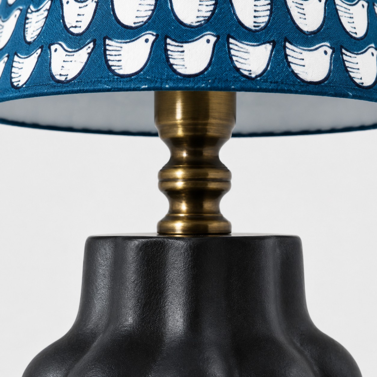 Antique-toned fitting and shade edge detail
