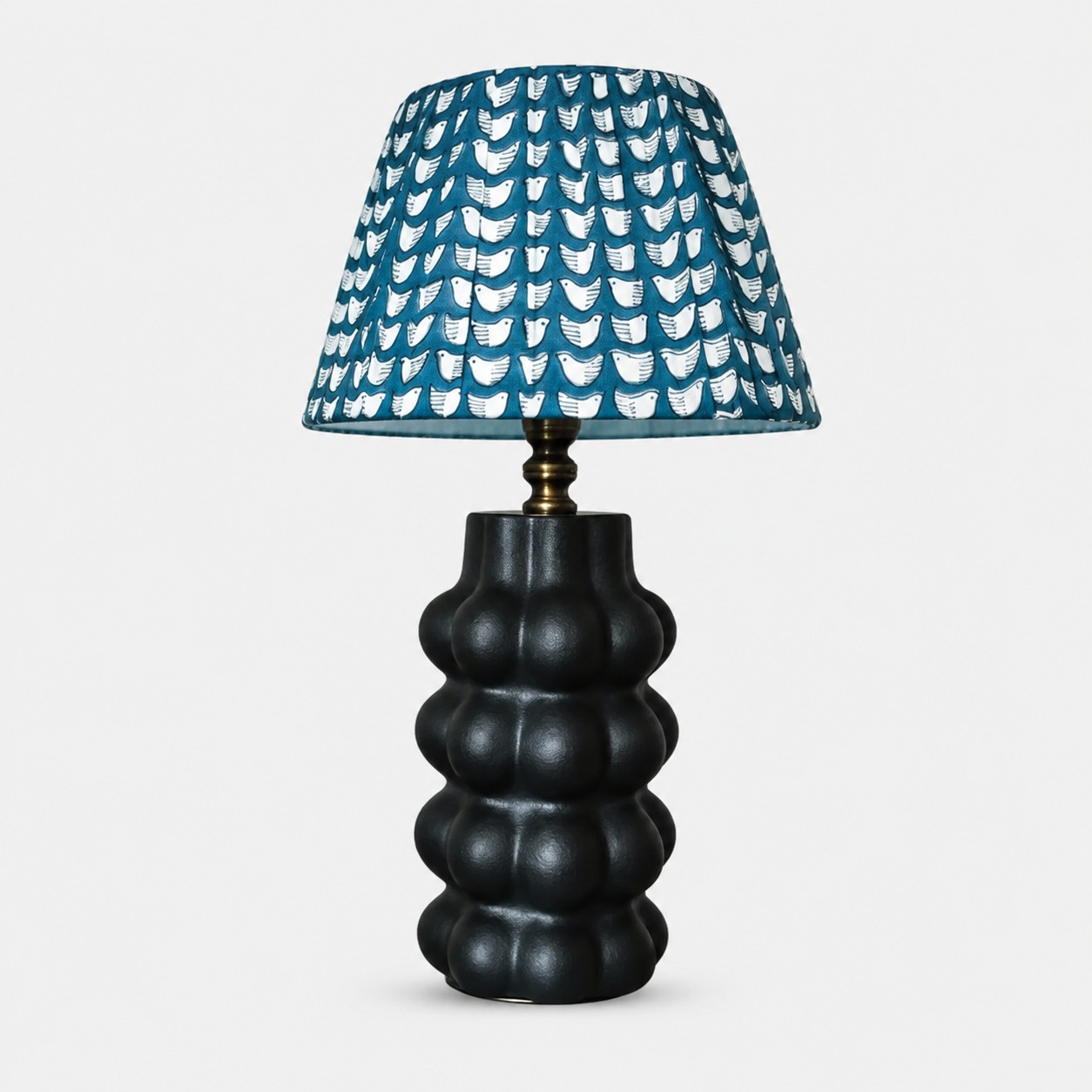 Sculptural ceramic table lamp with patterned fabric shade