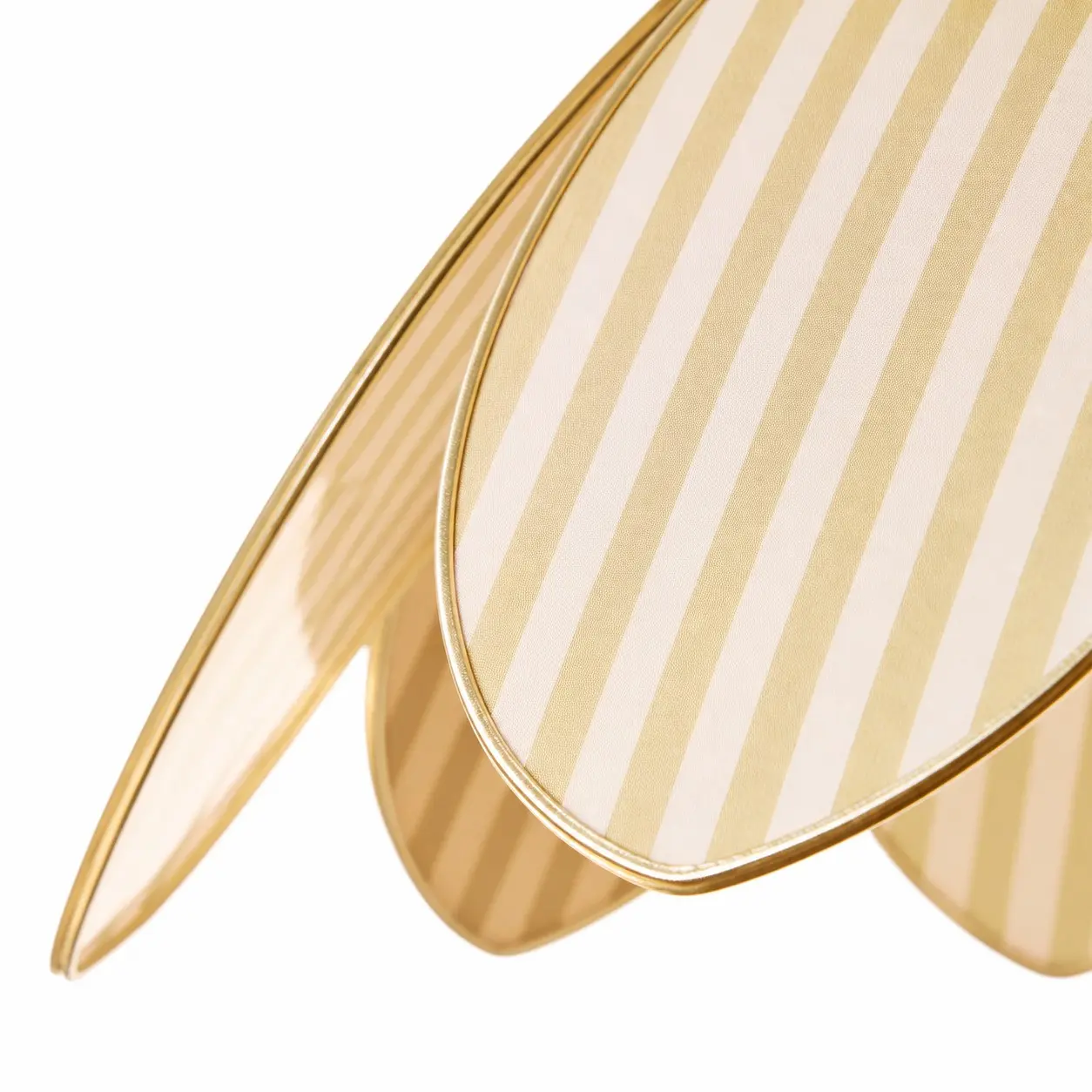 Close view of striped fabric and brass-tone petal trim